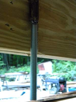 As we assembled each course we drilled holes at regular intervals, then sunk threaded rod down through all 10 courses to tie things together. 
